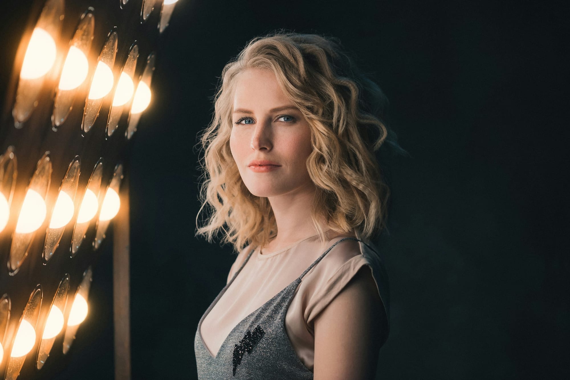 A model posing in front of lights for a modelling headshot