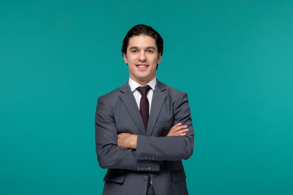 A professional headshots of a man posing in an authoritative yet welcoming manner